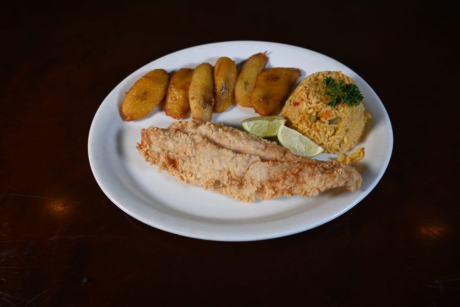 Fried fish filet with tostones and yellow rice