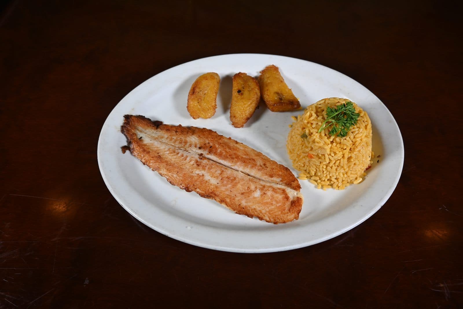 Grilled fish filet served with yellow rice
